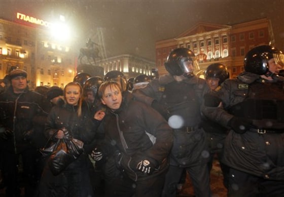 Police officers detain protesters during a rallyin central Moscow on Sunday. Opposition activists were calling for the resignation of Prime Minister Vladimir Putin.